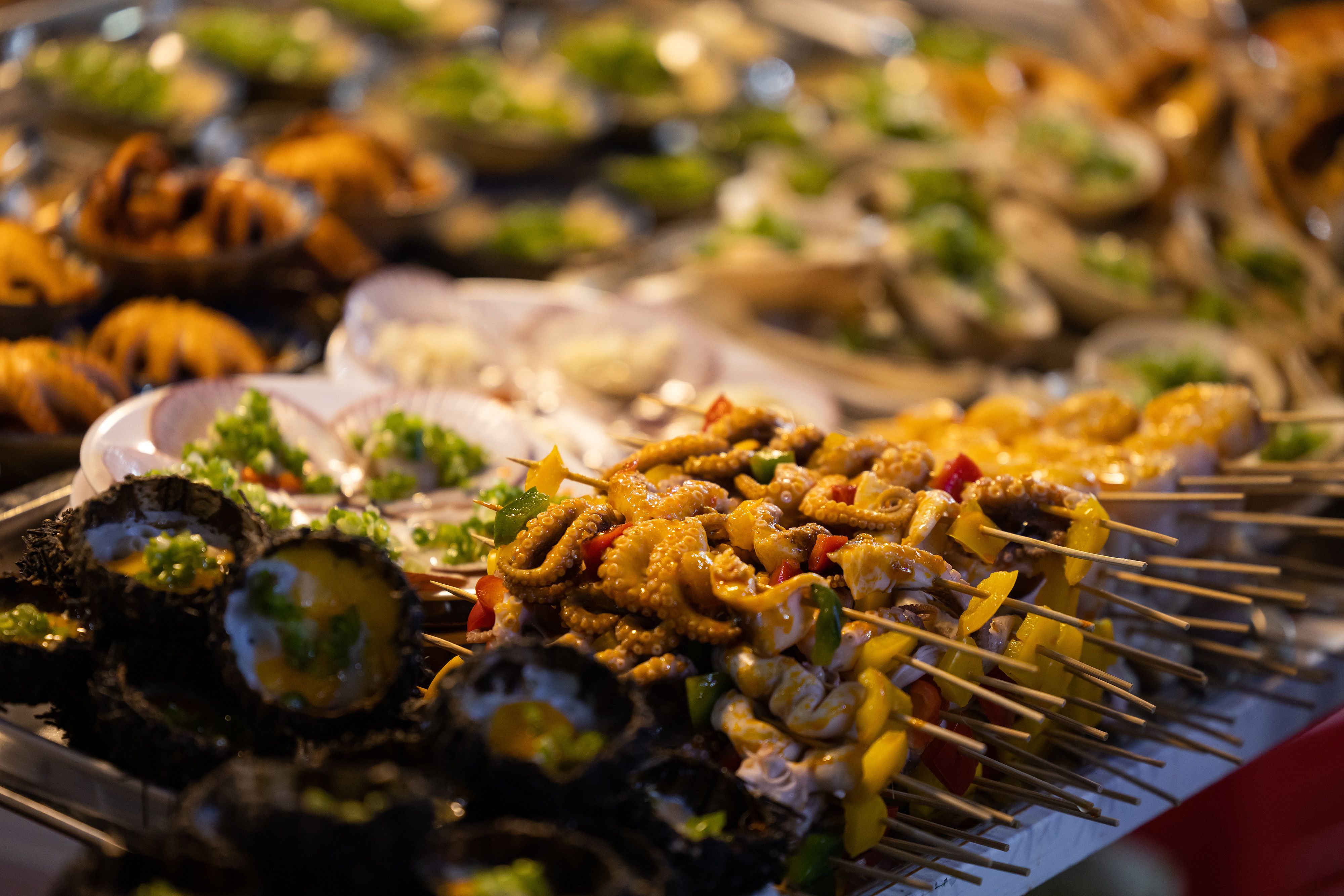 A variety of seafood skewers for sale at a market in Vietnam