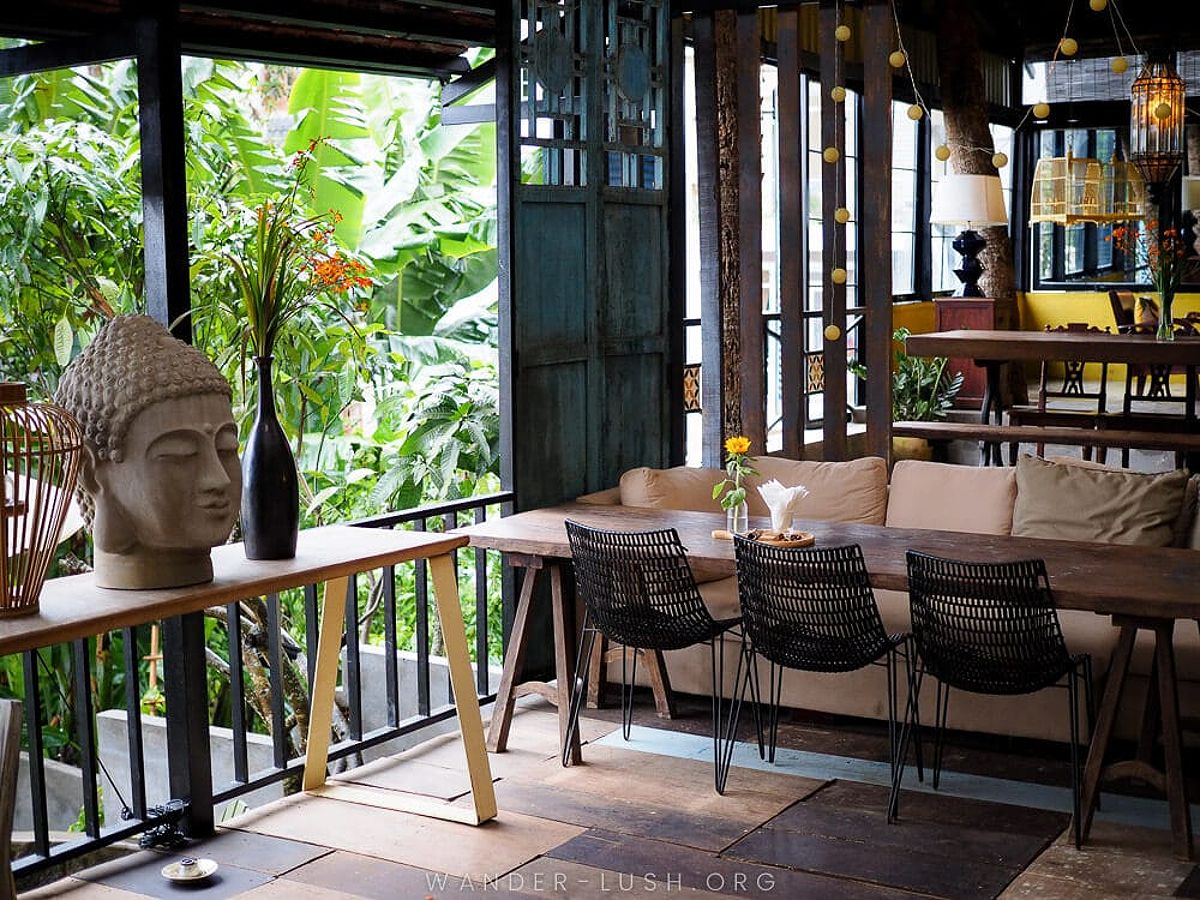 Comfy seating and a Buddha statue at Biang Garden Restaurant, a beautiful cafe in Dalat Vietnam.