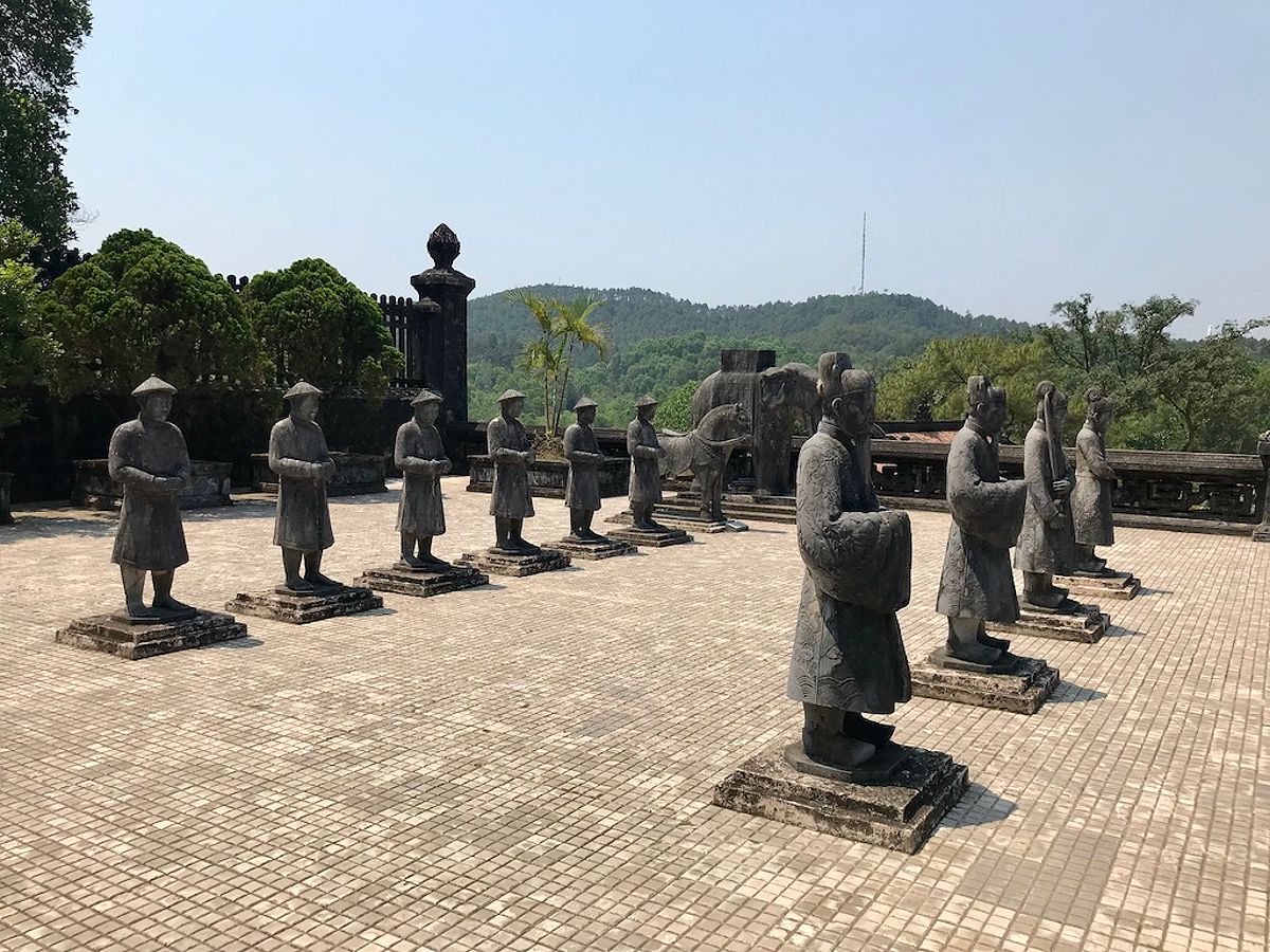 Life-size stone mandarin warrior figures at Khai Dinh royal tomb in Hue