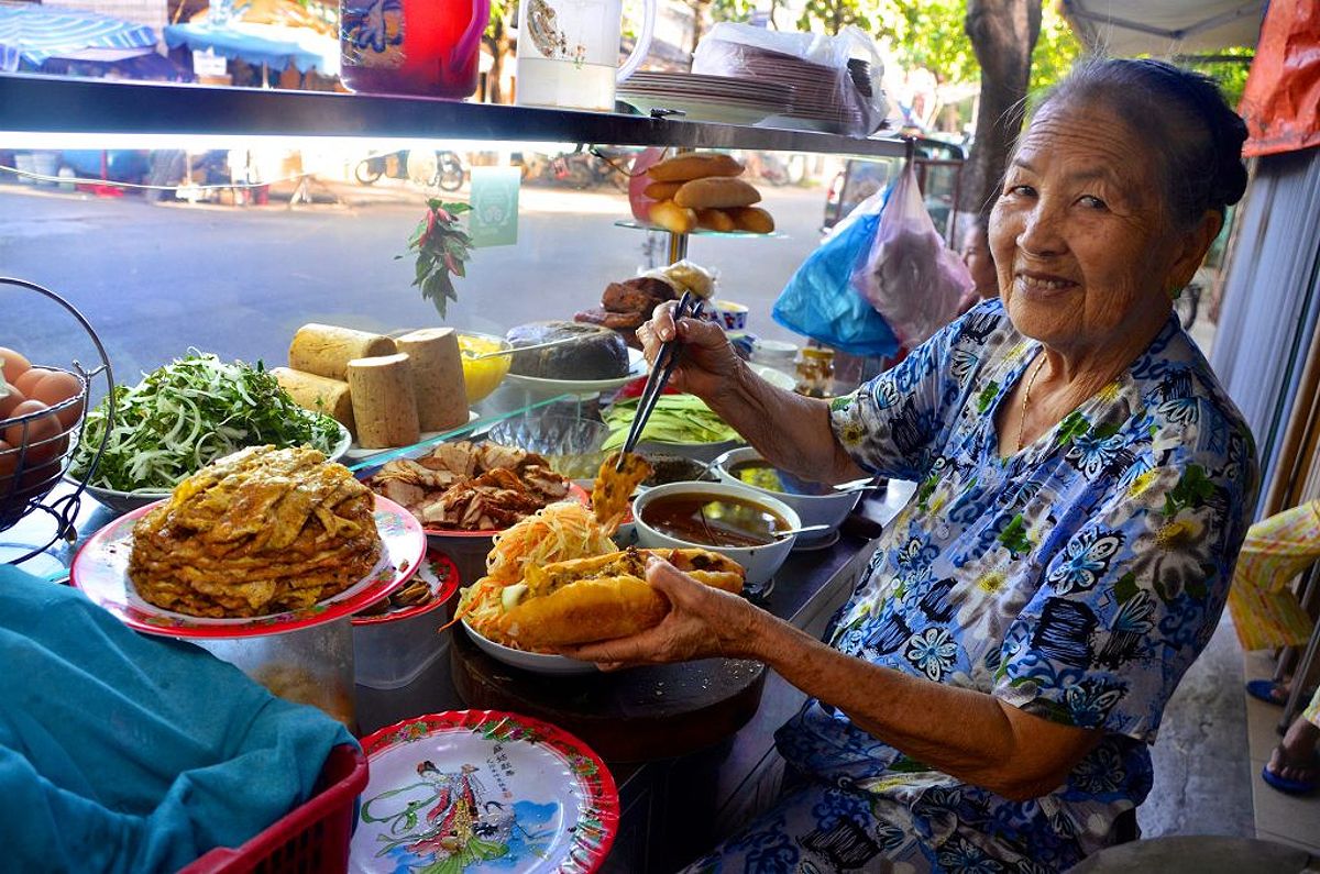 Local woman making street food sandwich in Vietnam