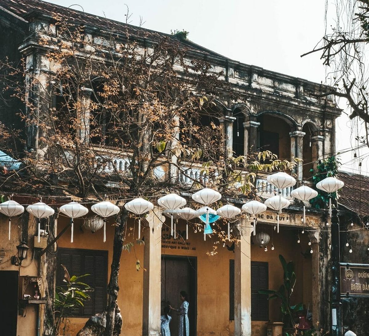 White lanterns in front of historic Hoi An building