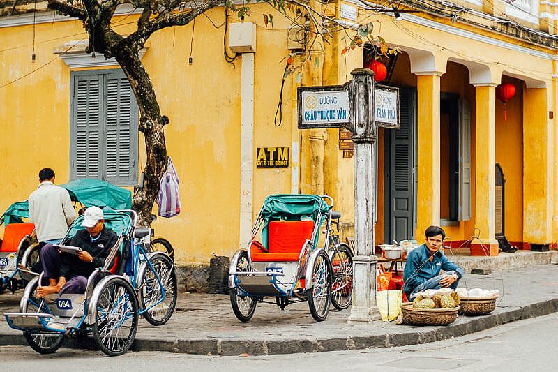 Yellow buildings and cyclos in Hoi An Ancient City